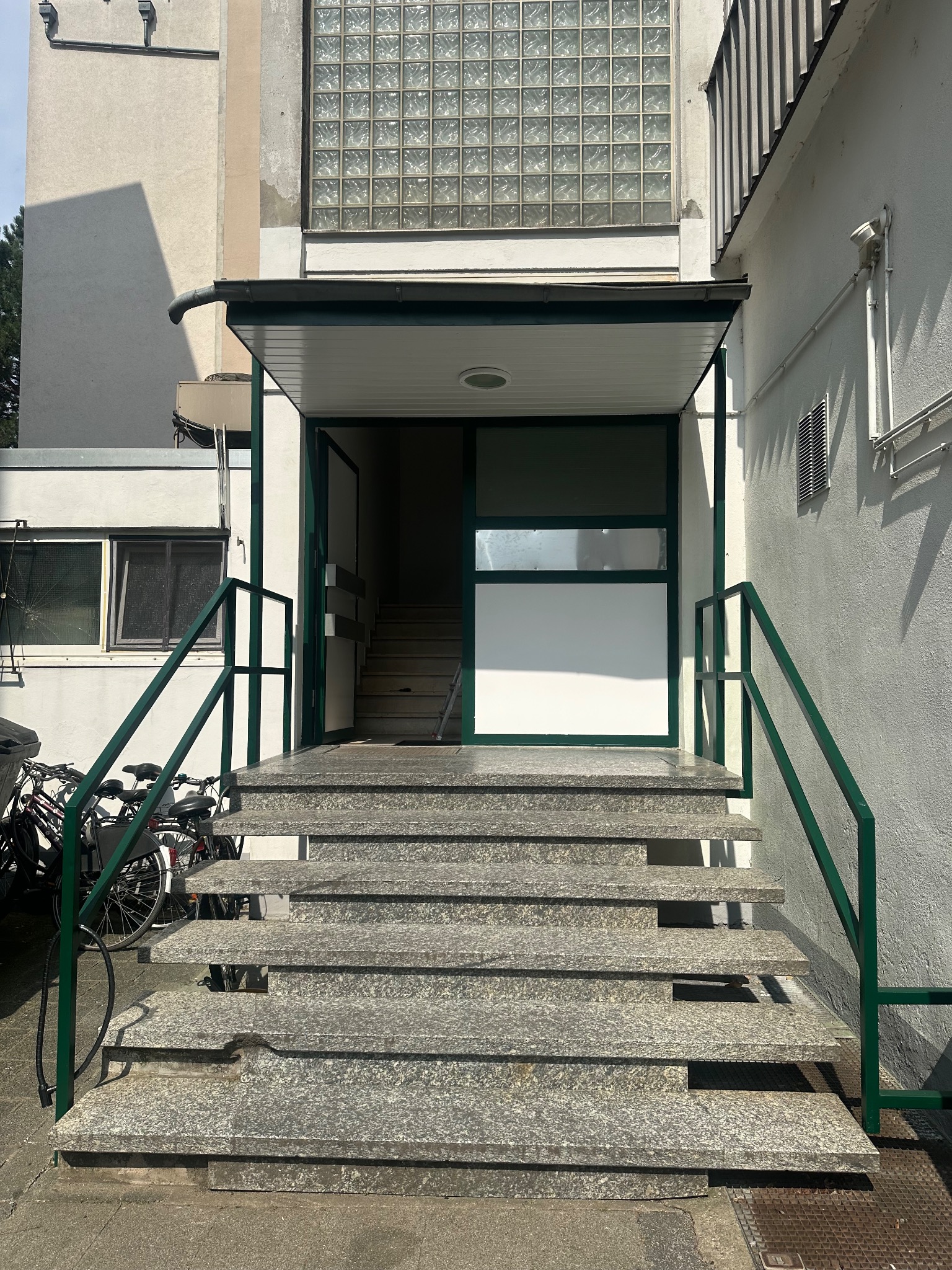 Renovierte Außentreppe mit neuem grünen Geländer